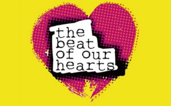 The words 'Beats of our heart' over a red heart on a yellow background