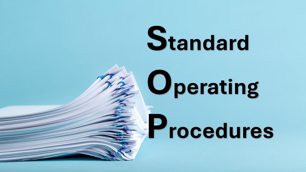 A pile of documents separated by paper clips with text overlaid. The text reads Standard Operating Procedures