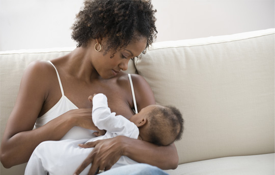 family with baby breastfeeding