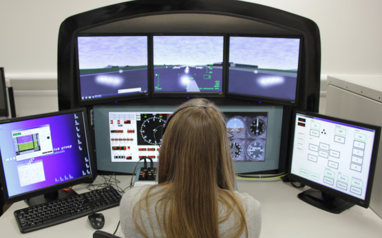Female student on flight simulator computer 