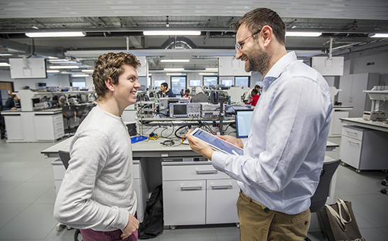 academic talking to student in lab