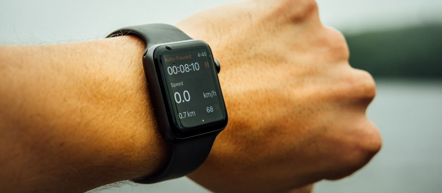 smart watch on male wrist showing running data
