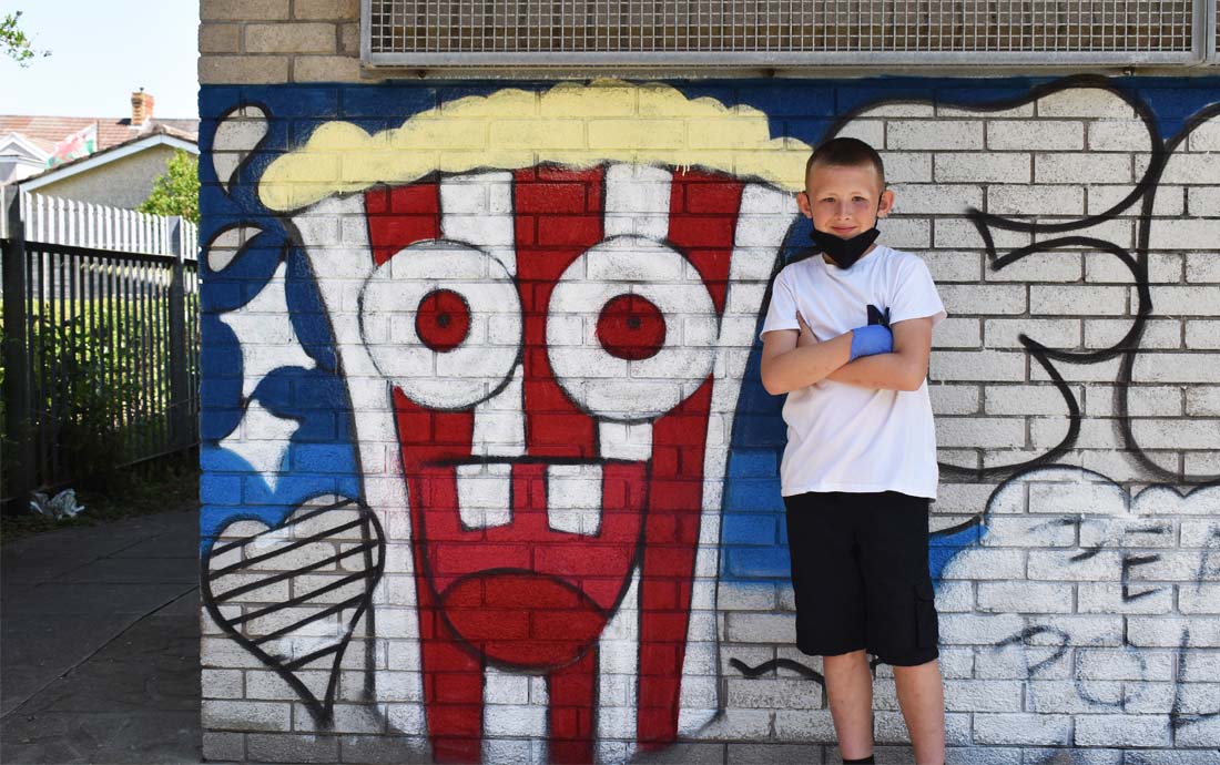 A young member of the club with a popcorn graffiti character