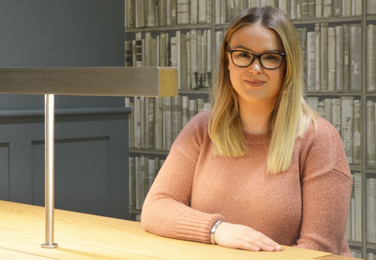 Student Smiling to camera at desk