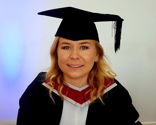 Female graduate smiling to camera