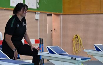 Hayley Baker, Swim coach, talking to student athletes whilst training