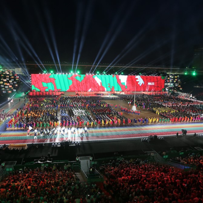 A large event with a big welsh flag behind 