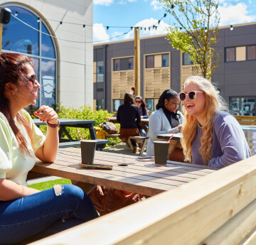 Students chatting sitting outside in the sun