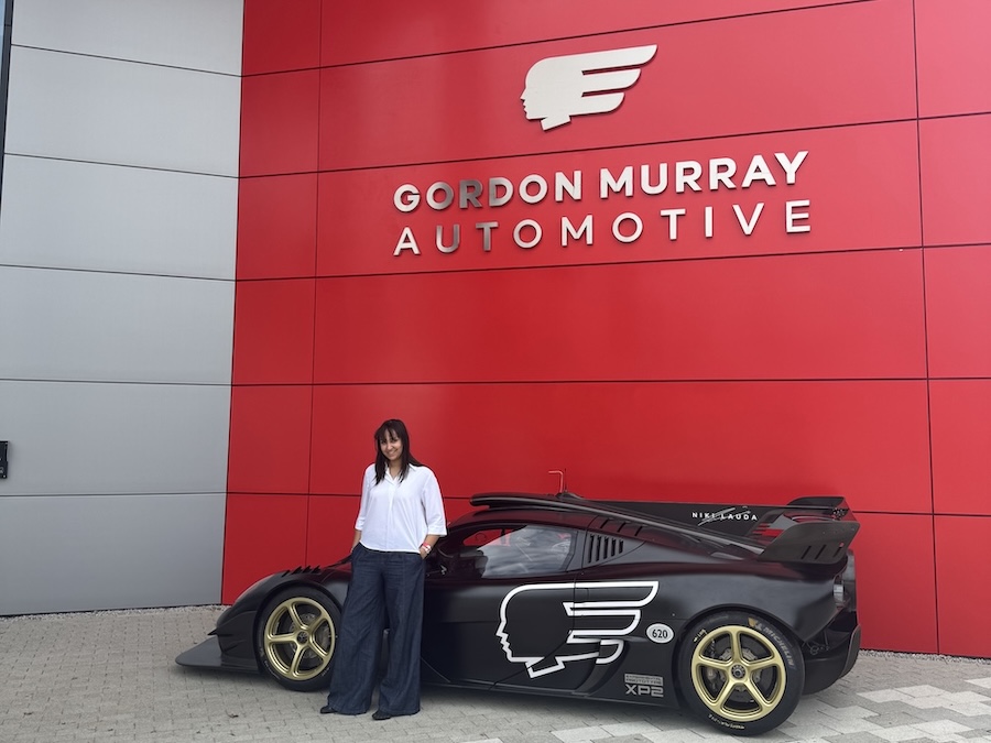 A woman standing next to a racing car
