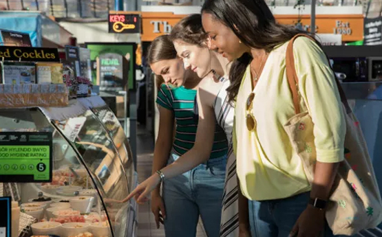Students looking at food through a counter