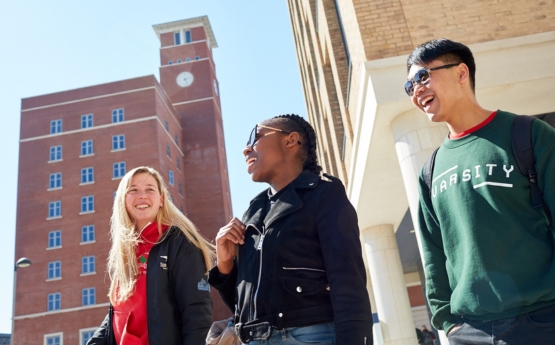 Three students walking together on Bay Campus