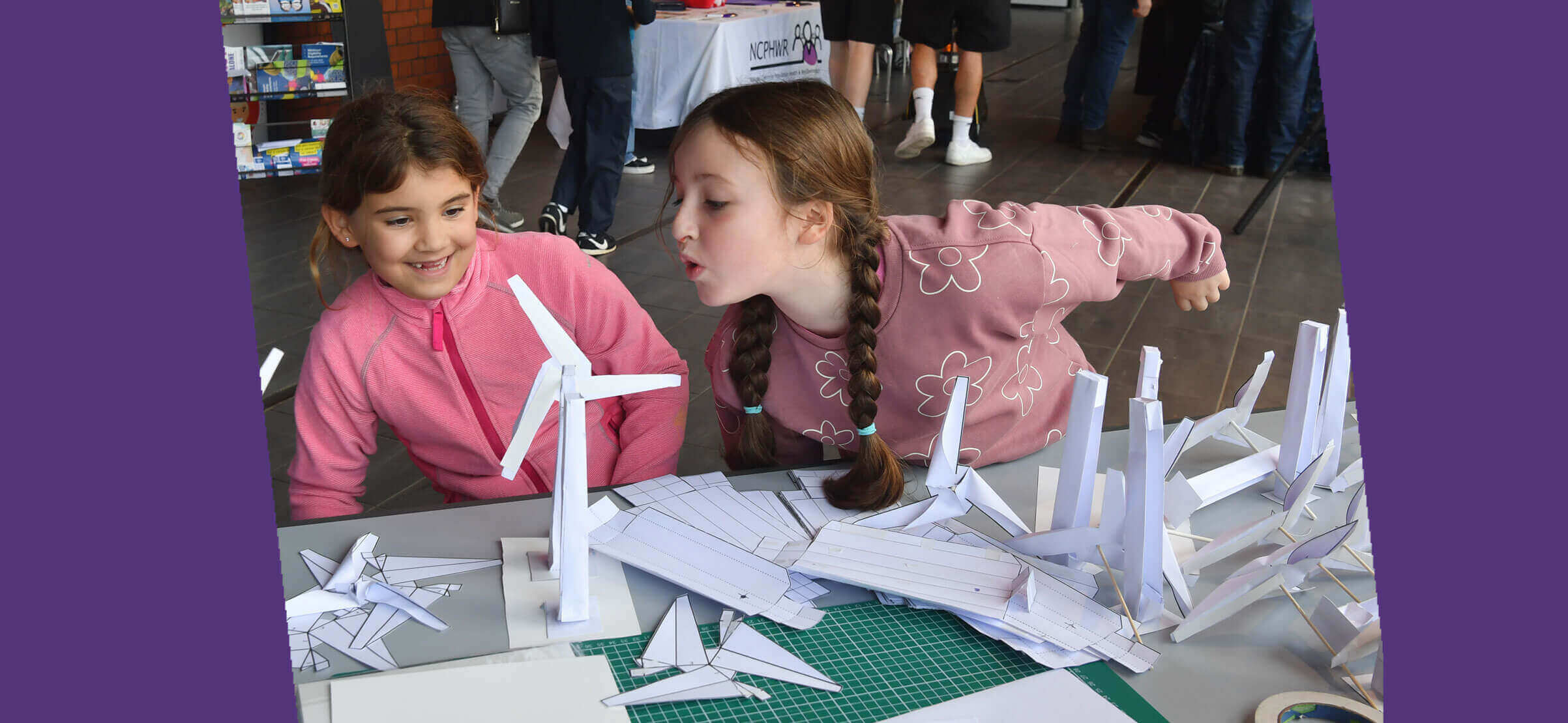 Girls creating wind turbines in paper at Swansea Science Festival 2023