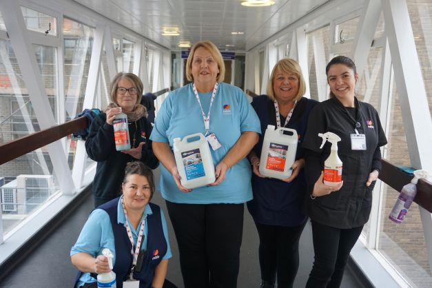 5 members of staff from the Cleaning team holding Biohygiene cleaning products and smiling