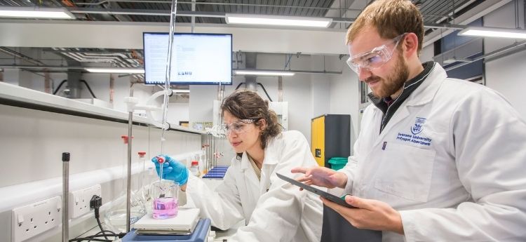 A male and female Swansea University student in chemistry laboratory