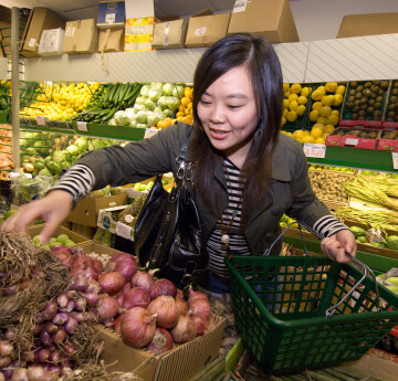 A female student shopping for fresh fruit and veg