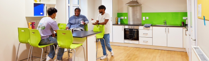 An image of students socialising in the shared kitchen area in the Bay Campus accommodation.