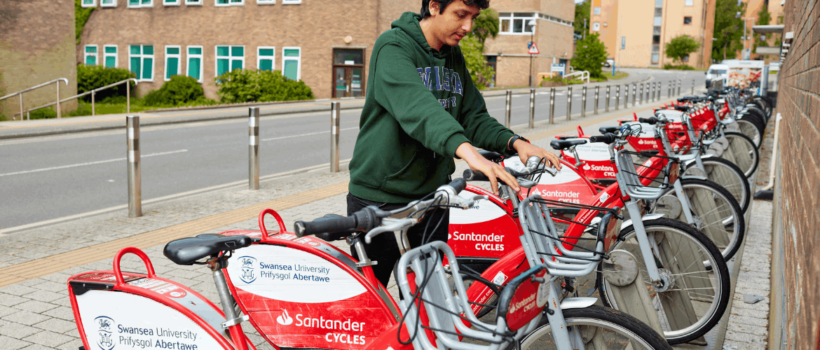Student unlocking a Santander Cycles bike at Singleton Campus 