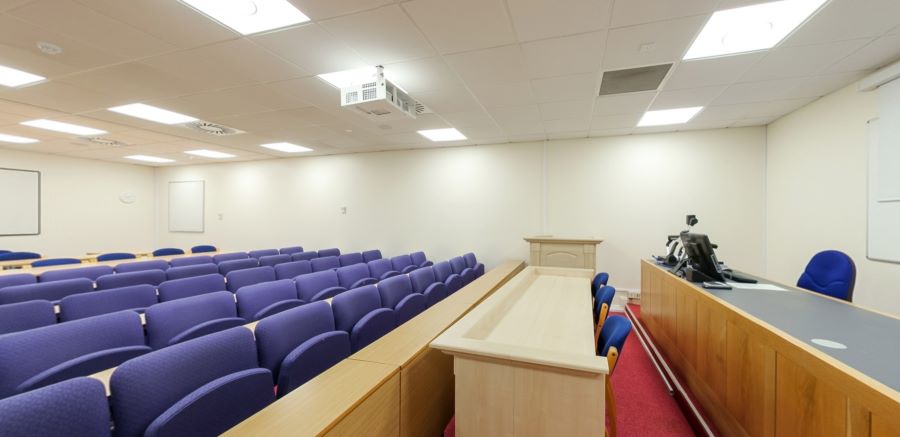 Moot court room with tiered seating, judge’s bench and lectern