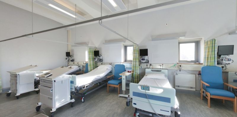 Hospital training ward with beds, monitors, chairs, and medical equipment