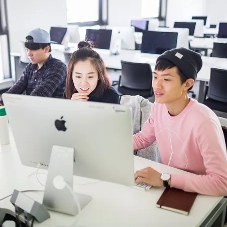 Students looking at a computer