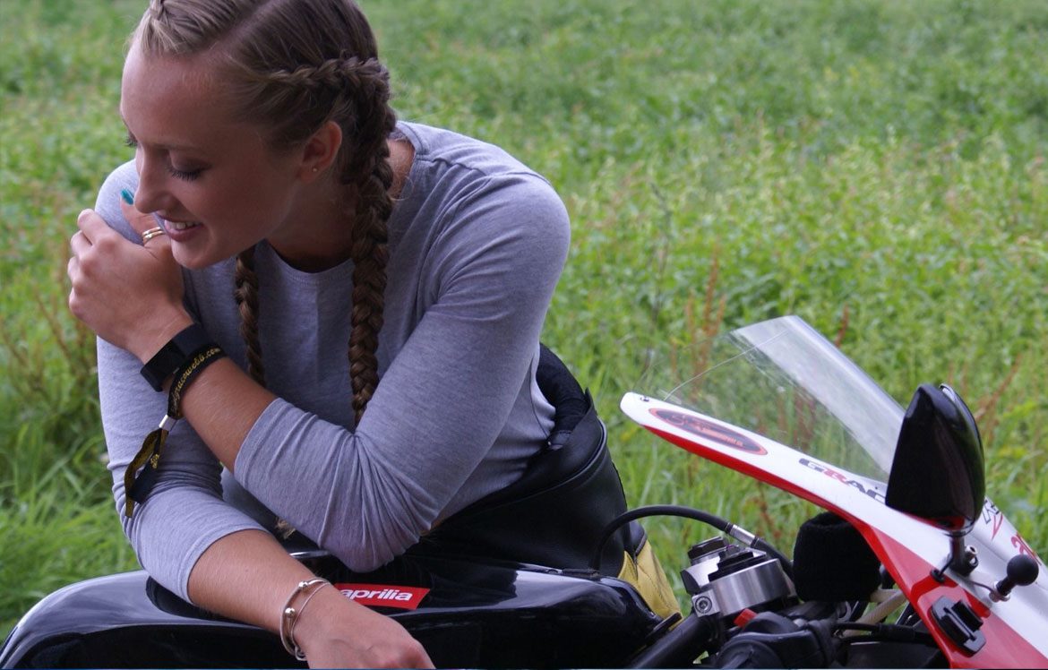 Woman leaning on motorbike