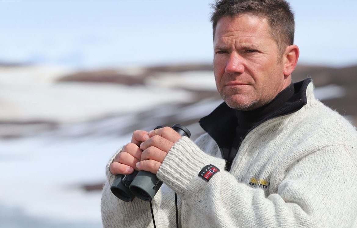 Steve Backshall holding binoculars 