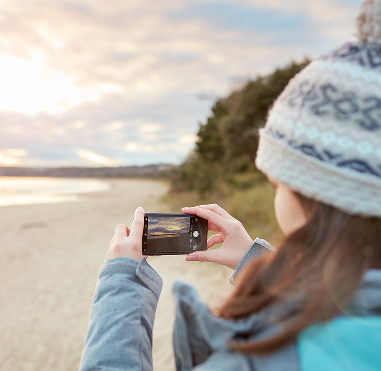 Image of student taking a picture of the beach