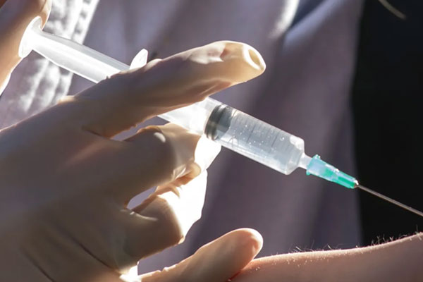 A needle being injected into an arm
